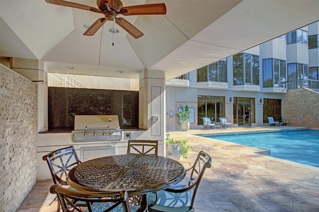 outdoor pool featuring area for grilling, an outdoor kitchen, outdoor dining space, and a patio area