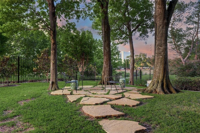 yard at dusk with a patio area and fence