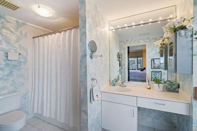 ensuite bathroom with visible vents, connected bathroom, toilet, tile patterned floors, and vanity