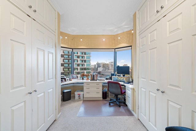 office space with light colored carpet and built in study area