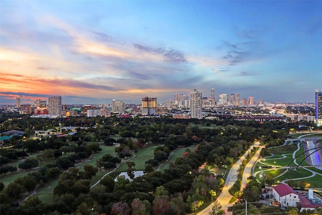 aerial view at dusk featuring a city view