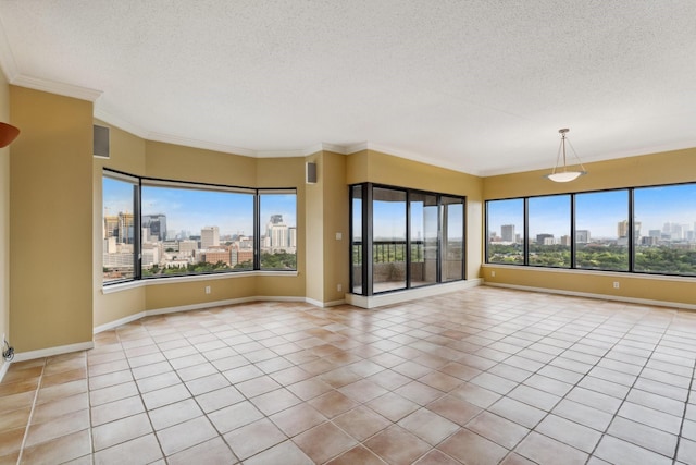 spare room featuring a view of skyline, a textured ceiling, light tile patterned floors, baseboards, and crown molding