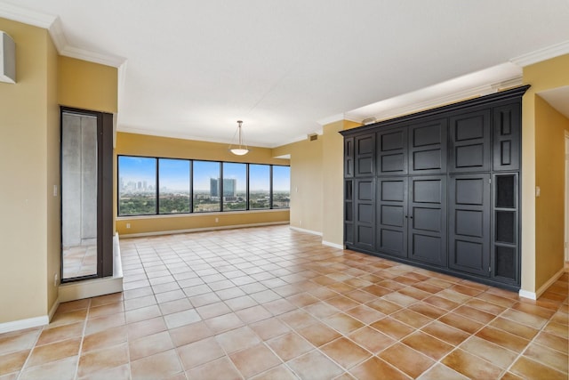 unfurnished room with light tile patterned floors, ornamental molding, and baseboards