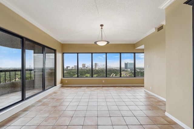 unfurnished room featuring crown molding, a textured ceiling, light tile patterned flooring, and baseboards