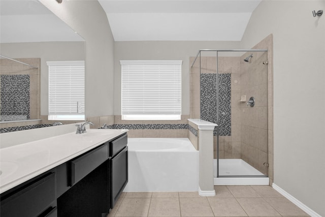 bathroom with tile patterned floors, a bath, a shower stall, and a sink