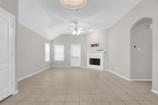 unfurnished living room featuring visible vents, a fireplace with raised hearth, baseboards, ceiling fan, and light tile patterned floors