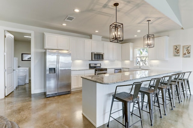 kitchen with finished concrete flooring, tasteful backsplash, visible vents, a breakfast bar, and stainless steel appliances