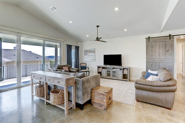 living room featuring concrete flooring, a barn door, lofted ceiling, and recessed lighting