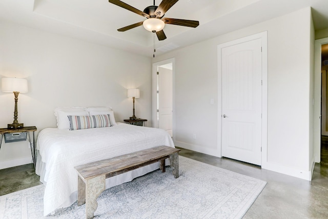 bedroom with finished concrete flooring, ceiling fan, and baseboards