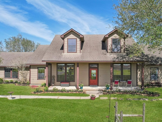 view of front of home featuring a front lawn and a shingled roof