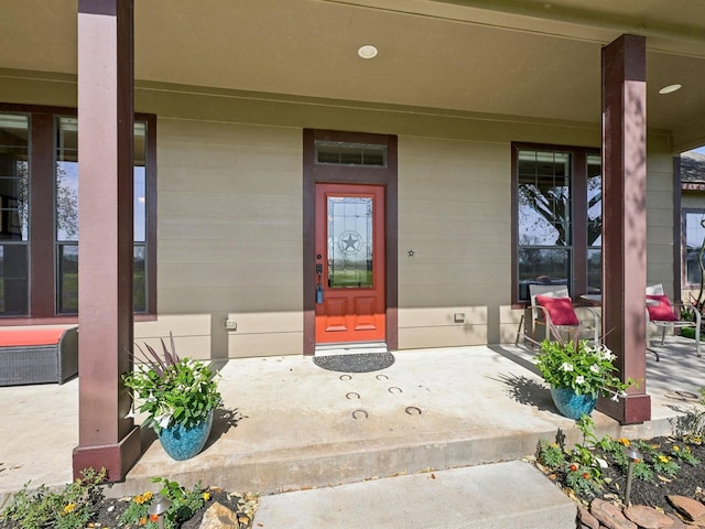 view of exterior entry featuring a porch