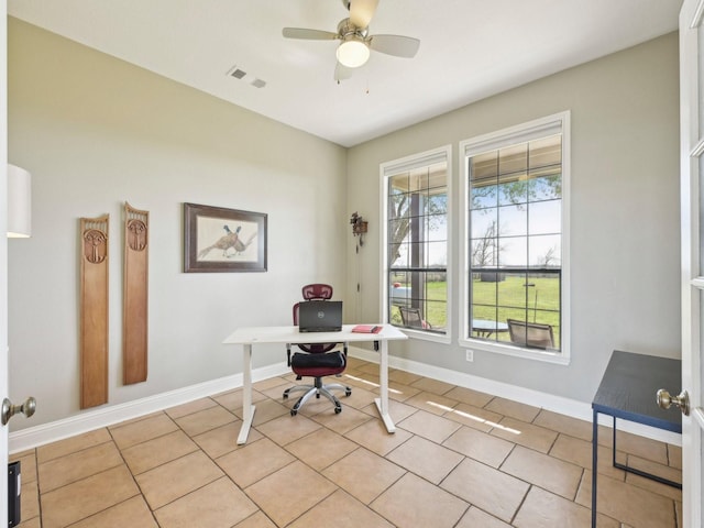 office with baseboards, visible vents, a ceiling fan, and light tile patterned flooring