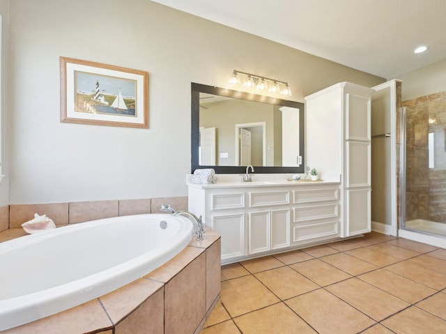 bathroom with tile patterned flooring, vanity, a bath, and a shower stall