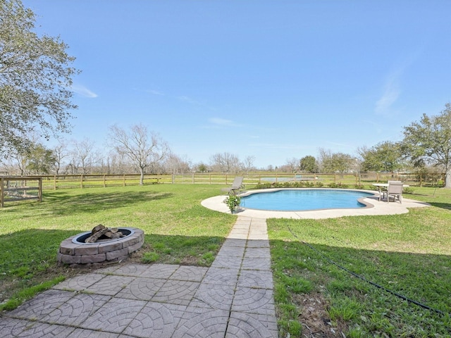 view of swimming pool featuring a patio area, a fenced backyard, a lawn, and a fire pit