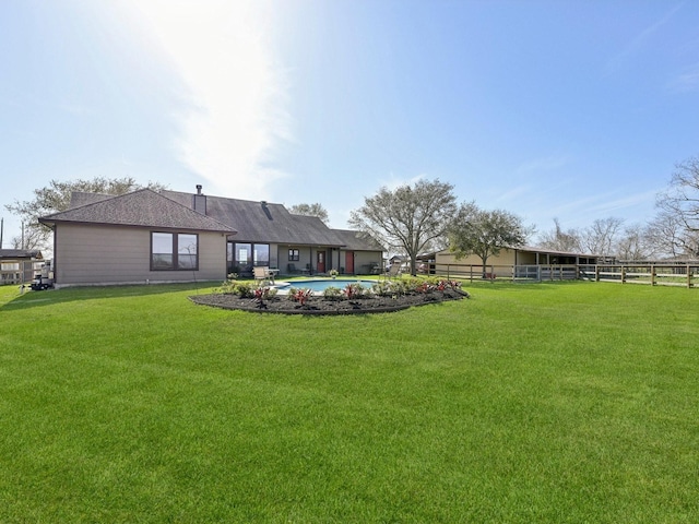 view of yard featuring fence and a fenced in pool