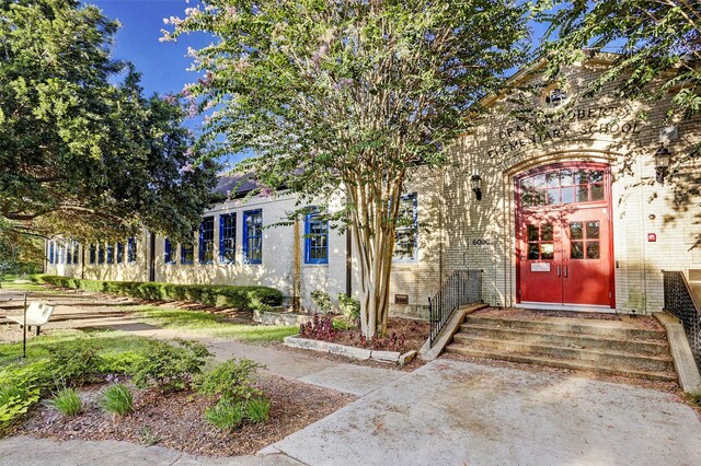 property entrance featuring brick siding