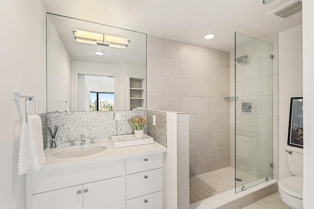 full bath with vanity, visible vents, a stall shower, toilet, and tasteful backsplash