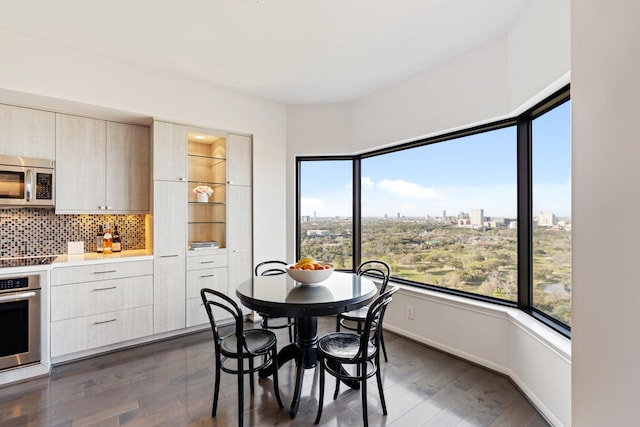 dining space with a view of city, baseboards, and dark wood-style flooring