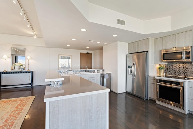 kitchen featuring visible vents, modern cabinets, tasteful backsplash, stainless steel appliances, and dark wood-style flooring