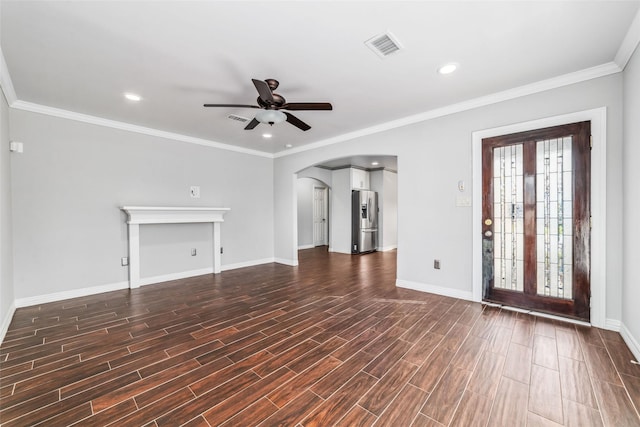 unfurnished living room with baseboards, arched walkways, dark wood-style flooring, and ceiling fan