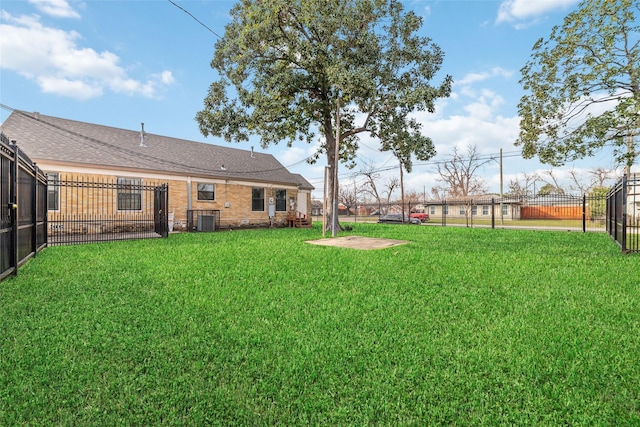 view of yard featuring central AC unit and fence