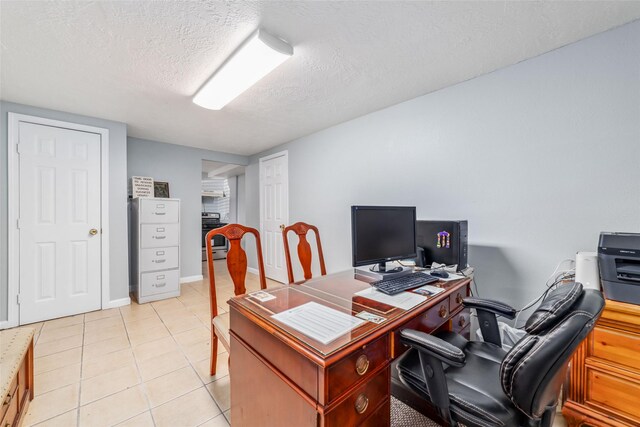 office area with light tile patterned floors and a textured ceiling