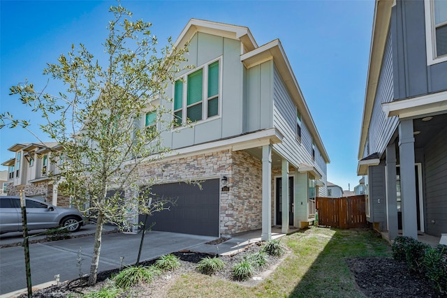 view of front of home featuring stone siding, board and batten siding, concrete driveway, and an attached garage