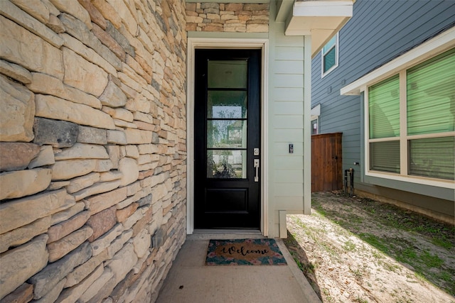 entrance to property featuring stone siding