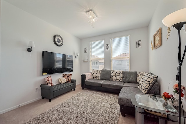 living room with baseboards and light colored carpet