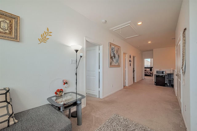 hallway featuring light carpet, recessed lighting, and attic access