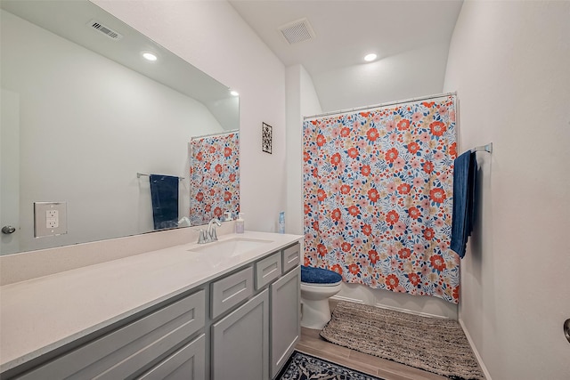 bathroom featuring vanity, visible vents, wood tiled floor, recessed lighting, and toilet