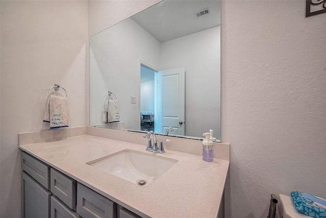 bathroom with visible vents and vanity