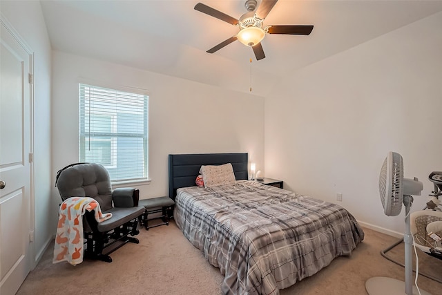 bedroom featuring a ceiling fan, light colored carpet, and baseboards