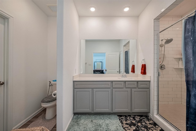 full bathroom featuring visible vents, toilet, a stall shower, baseboards, and vanity