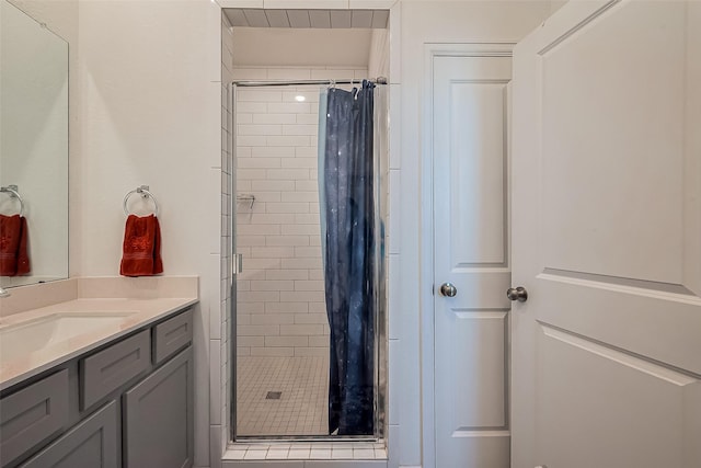 full bath with vanity and a shower stall