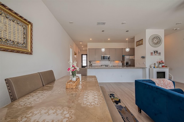 dining room with visible vents, recessed lighting, and light wood-type flooring