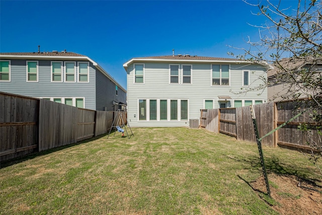 back of property featuring cooling unit, a lawn, and a fenced backyard