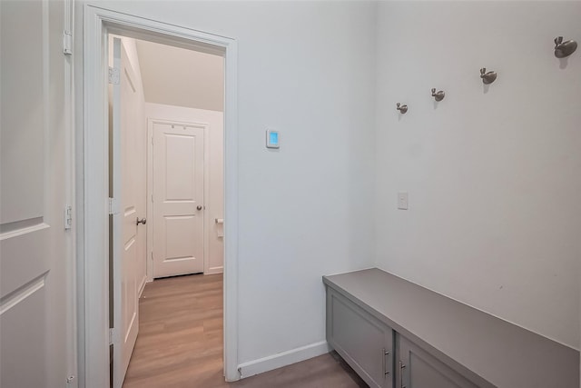 mudroom featuring baseboards and light wood finished floors