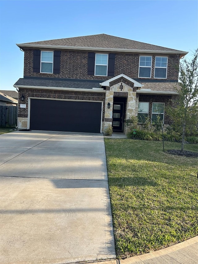 traditional-style house with a front yard, stone siding, brick siding, and driveway