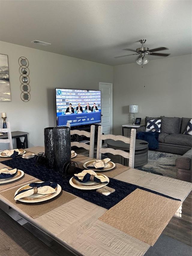 dining space featuring ceiling fan, visible vents, and wood finished floors