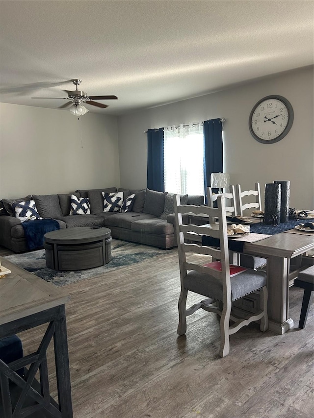 dining room with ceiling fan, a textured ceiling, and wood finished floors