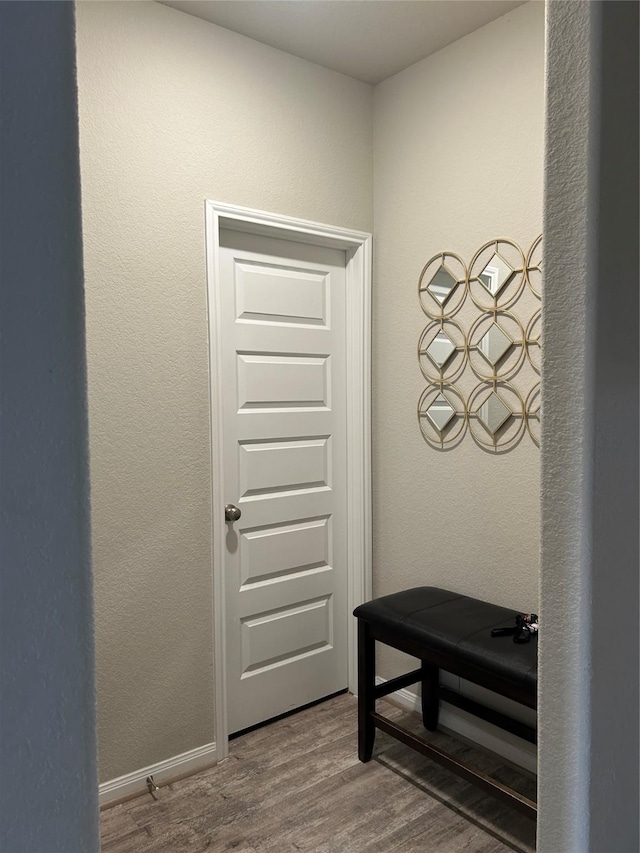 doorway to outside featuring wood finished floors and baseboards