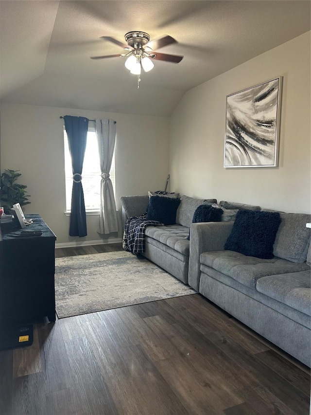 living room featuring a ceiling fan, vaulted ceiling, and wood finished floors