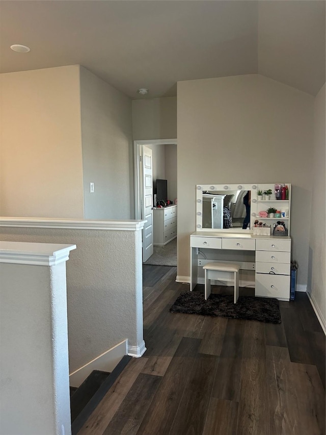 office featuring lofted ceiling, dark wood-style flooring, and baseboards