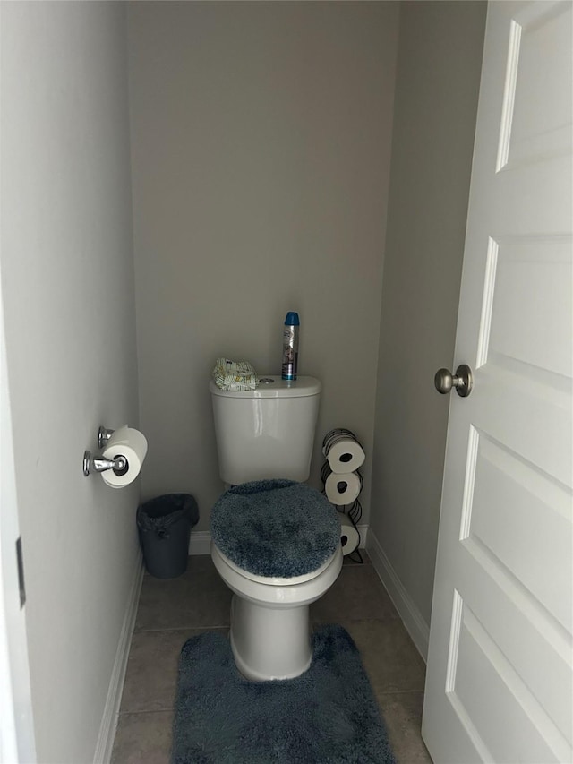 bathroom featuring tile patterned floors, toilet, and baseboards