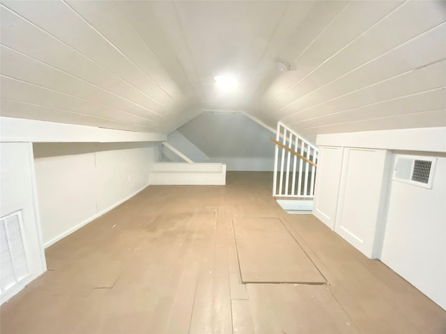 bonus room with vaulted ceiling and visible vents