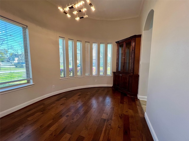 unfurnished room featuring dark wood-type flooring and baseboards