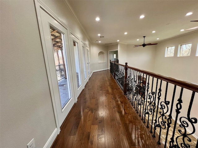 corridor featuring recessed lighting, crown molding, baseboards, and hardwood / wood-style floors