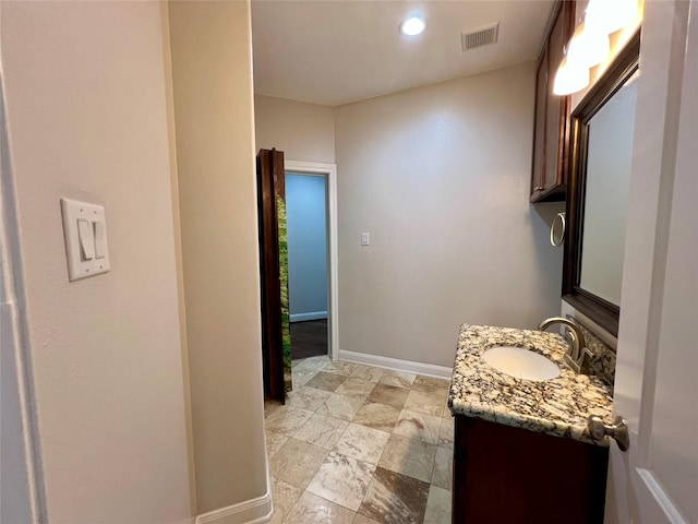 bathroom with visible vents, vanity, and baseboards