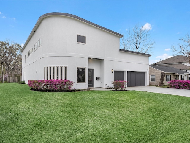 exterior space featuring a front lawn, concrete driveway, a garage, and stucco siding